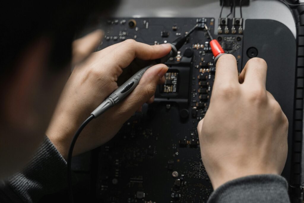 pexels photo 6755135 6755135 Close-up of hands repairing a circuit board using a soldering iron, emphasizing technical skill.